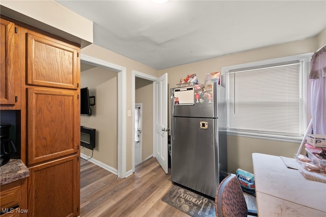 kitchen with stainless steel refrigerator and light wood-type flooring