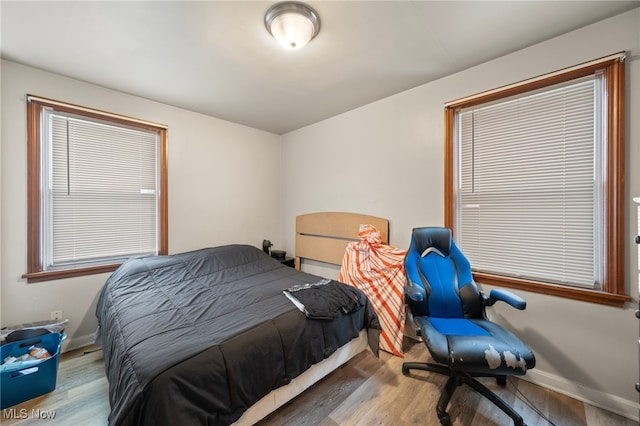 bedroom with hardwood / wood-style flooring