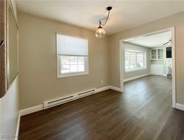 unfurnished dining area with dark hardwood / wood-style flooring, a wealth of natural light, ceiling fan, and baseboard heating