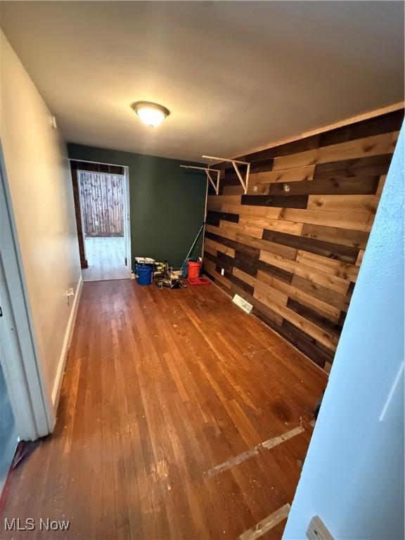 corridor with hardwood / wood-style floors