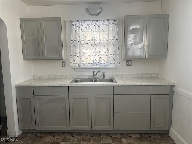 kitchen with gray cabinetry and sink