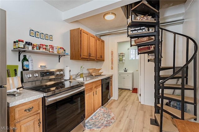 kitchen with stainless steel range with electric stovetop, black dishwasher, sink, and light wood-type flooring