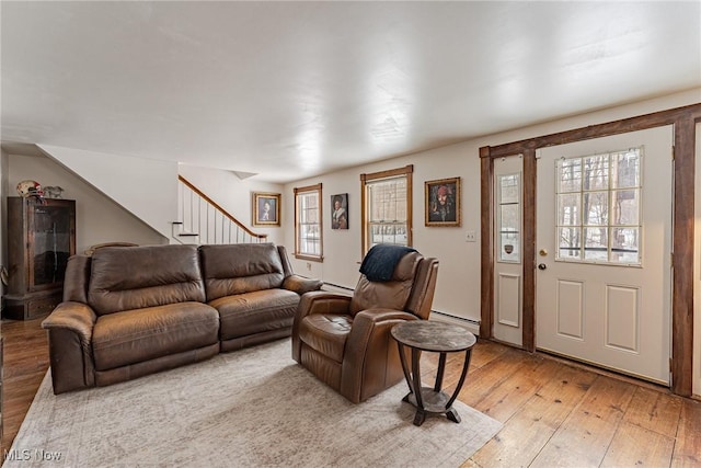 living room with a baseboard radiator and light wood-type flooring