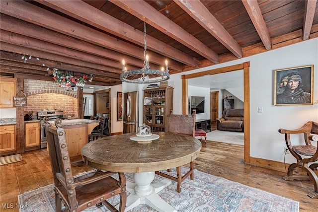 dining space with wooden ceiling, beam ceiling, and light hardwood / wood-style flooring