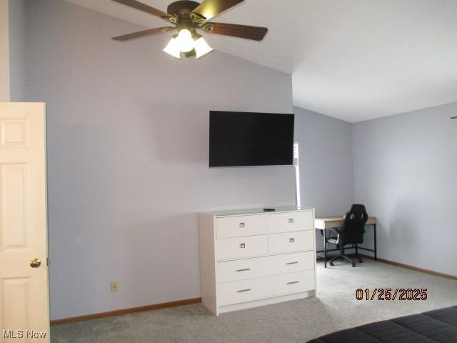 interior space featuring vaulted ceiling, ceiling fan, and light colored carpet