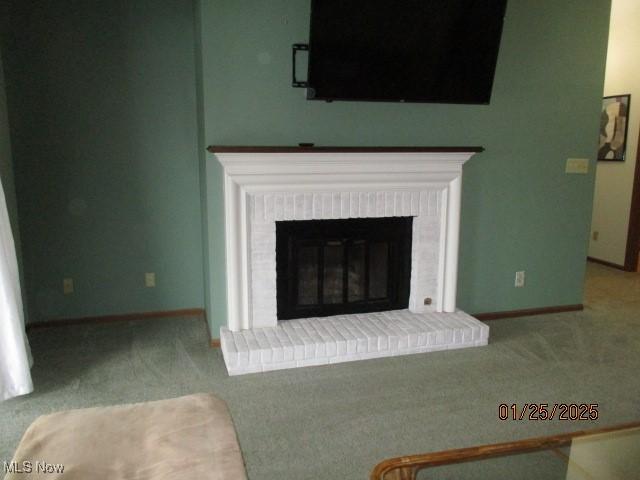 carpeted living room featuring a fireplace