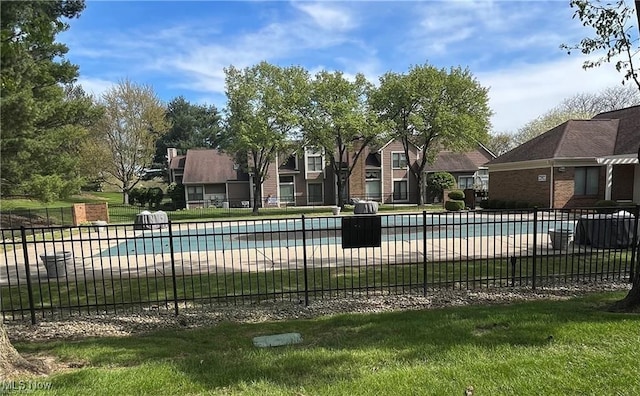 view of pool featuring a yard