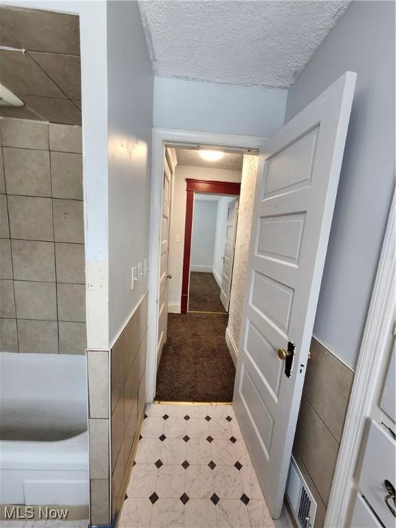 hallway featuring a textured ceiling