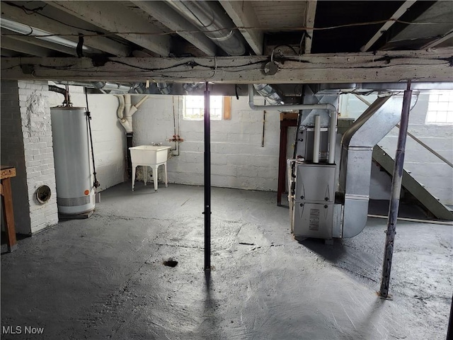 basement featuring sink and water heater