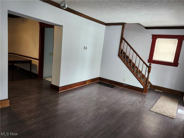 interior space featuring crown molding, dark hardwood / wood-style flooring, and a textured ceiling