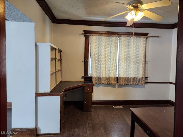 unfurnished office featuring ceiling fan, dark wood-type flooring, ornamental molding, and a textured ceiling