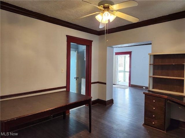 unfurnished office featuring ceiling fan, crown molding, dark wood-type flooring, and a textured ceiling