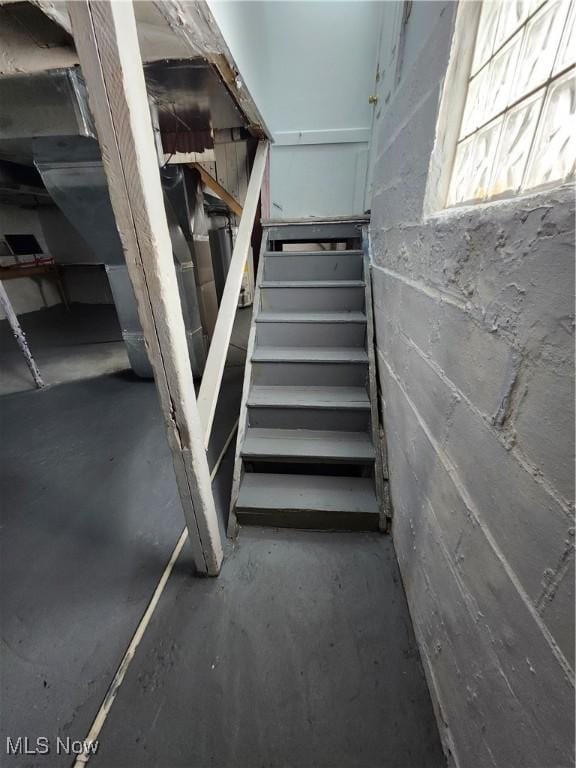 staircase featuring concrete flooring