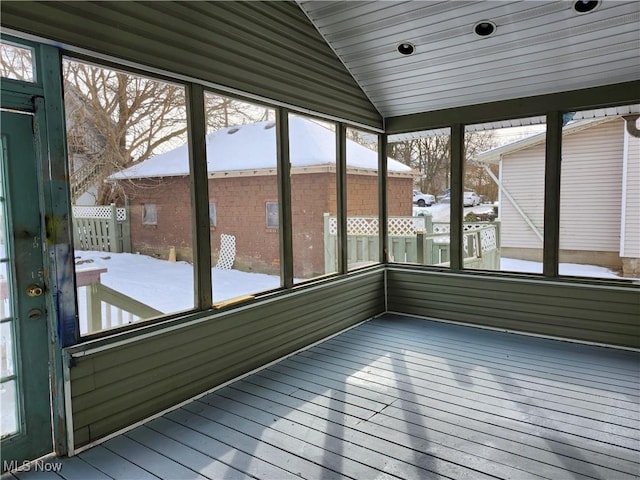 unfurnished sunroom featuring wood ceiling and vaulted ceiling