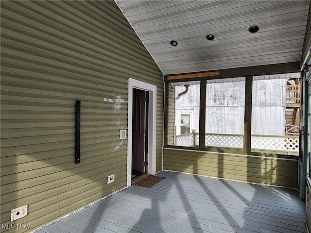 unfurnished sunroom featuring lofted ceiling and wooden ceiling