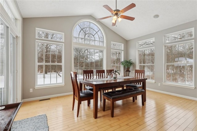 sunroom / solarium featuring ceiling fan, vaulted ceiling, and a wealth of natural light