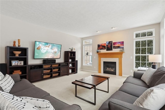 carpeted living room featuring a textured ceiling