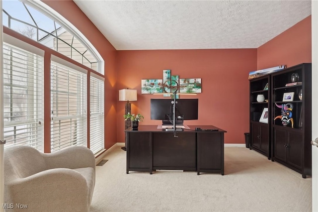 office area featuring light colored carpet and a textured ceiling