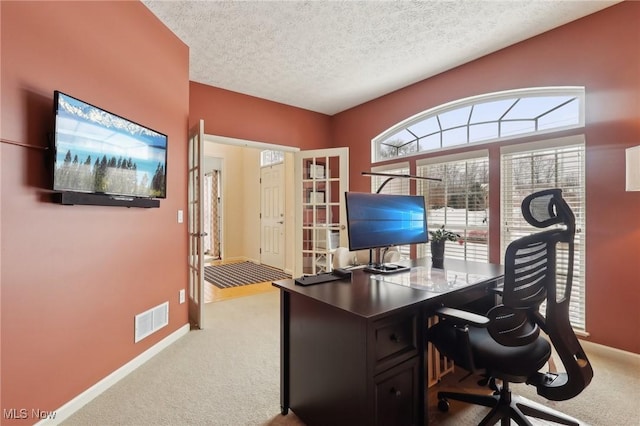 office with carpet and a textured ceiling