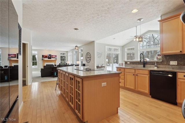 kitchen with pendant lighting, sink, a center island, black dishwasher, and tasteful backsplash