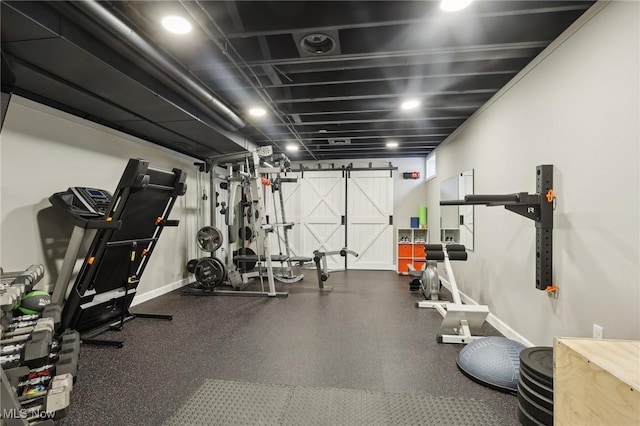 exercise area with a barn door