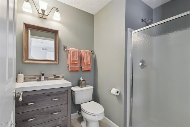 bathroom with walk in shower, tile patterned floors, vanity, and toilet