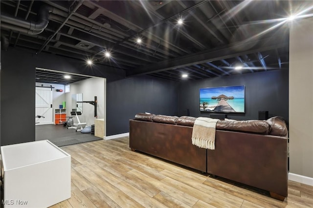 living room featuring a barn door and hardwood / wood-style floors