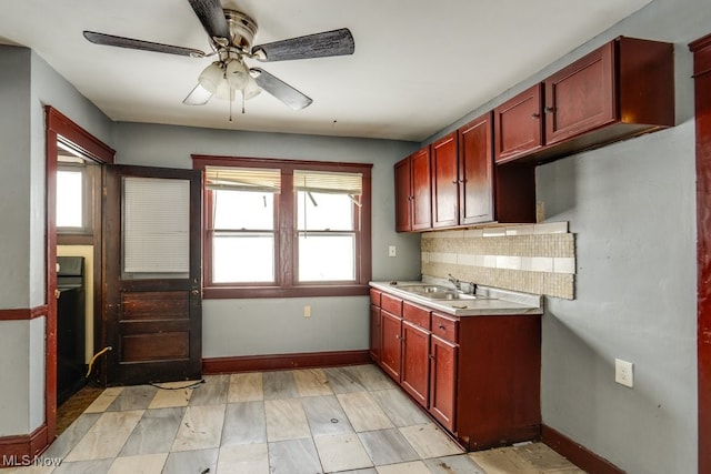 kitchen with tasteful backsplash, sink, plenty of natural light, and ceiling fan