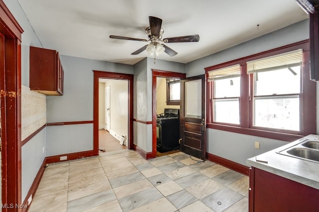 kitchen with ceiling fan, sink, and black gas range oven