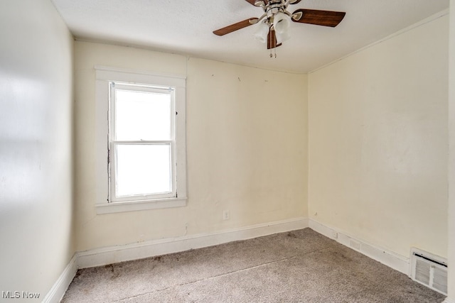 carpeted spare room featuring a wealth of natural light and ceiling fan