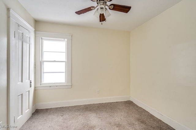 empty room featuring carpet flooring and ceiling fan