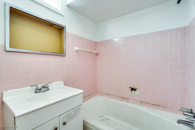 bathroom featuring tile walls, a bath, vanity, and decorative backsplash