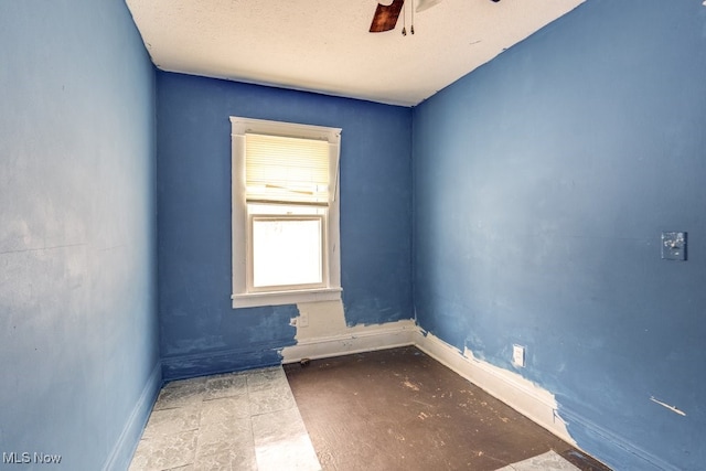 unfurnished room with a textured ceiling and ceiling fan