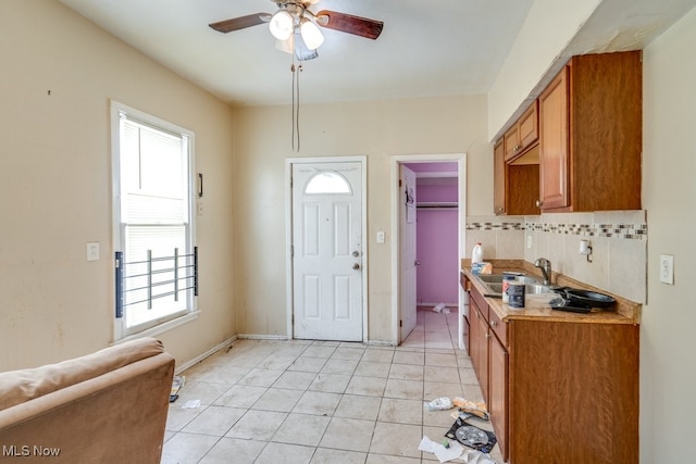 interior space with ceiling fan and sink