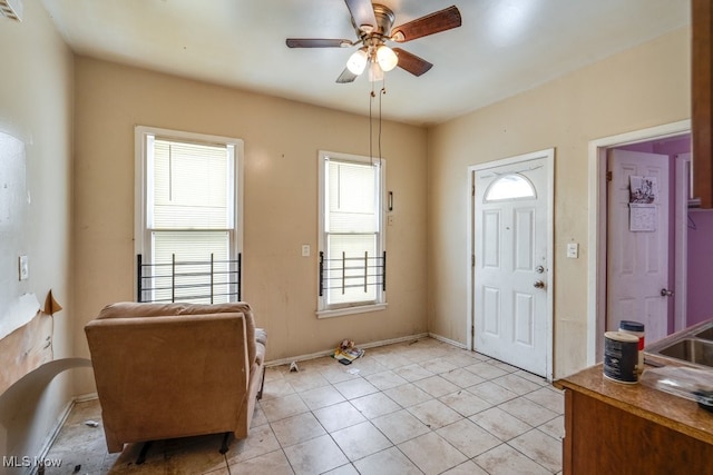 tiled entryway with ceiling fan