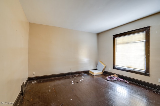 spare room featuring dark hardwood / wood-style floors