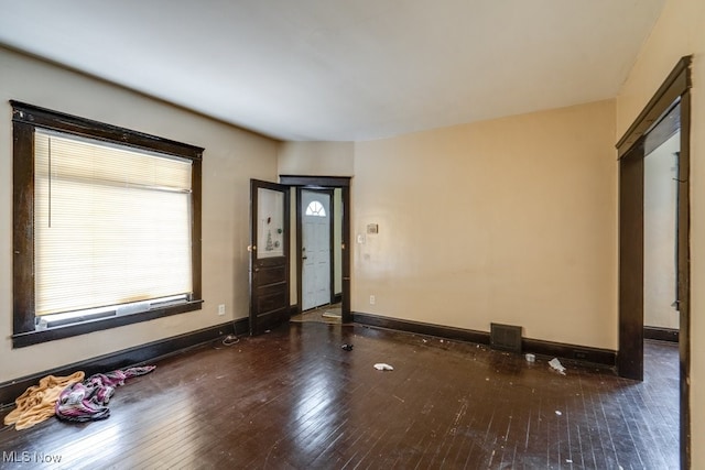 empty room with dark wood-type flooring