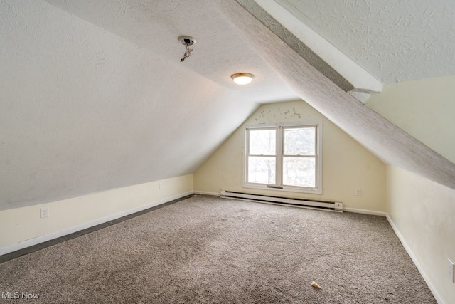 bonus room with vaulted ceiling, carpet floors, a textured ceiling, and a baseboard heating unit