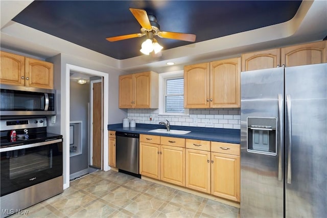 kitchen with light brown cabinetry, sink, decorative backsplash, ceiling fan, and stainless steel appliances