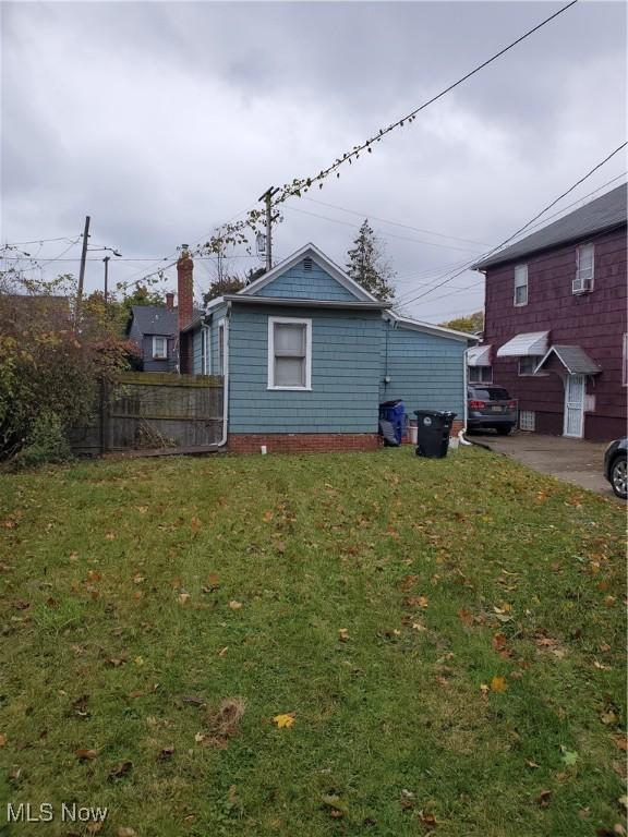 view of side of property featuring a yard