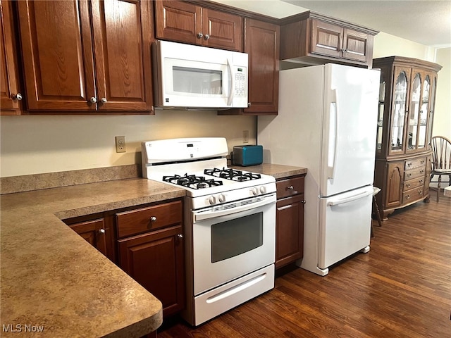 kitchen featuring white appliances and dark wood-type flooring