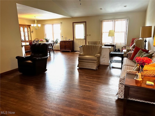 living room with vaulted ceiling, dark hardwood / wood-style floors, and an inviting chandelier