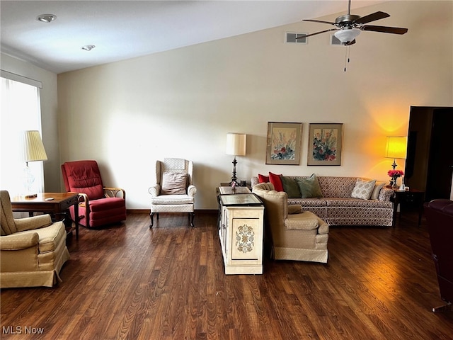 living room featuring lofted ceiling, dark wood-type flooring, and ceiling fan