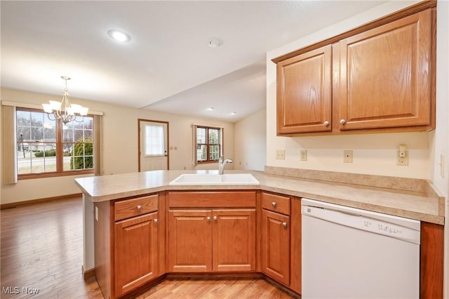1089 Park Pl, Niles, OH 44446 - kitchen with decorative light fixtures, dishwasher, sink, kitchen peninsula, and light hardwood / wood-style flooring