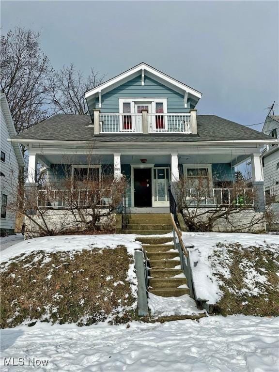 front of property featuring a balcony and covered porch