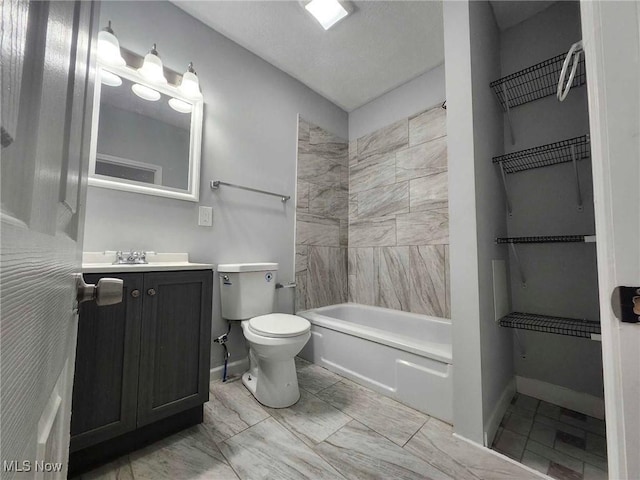 full bathroom with vanity, tiled shower / bath combo, and toilet