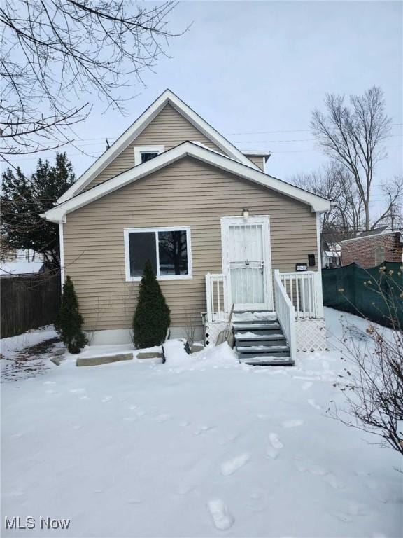 view of snow covered rear of property