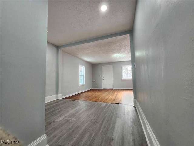 empty room with hardwood / wood-style flooring and a textured ceiling