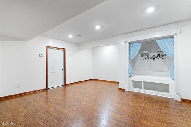 interior space featuring built in shelves and hardwood / wood-style flooring