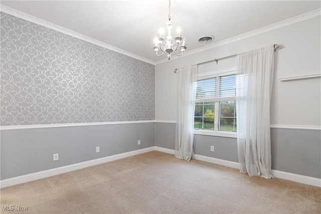 empty room with an inviting chandelier, light colored carpet, and crown molding